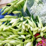 Consultative Selling - A woman is selling flowers on a cart