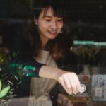 Close Sale - Ethnic woman in casual clothes hanging up sign on door after end of workday