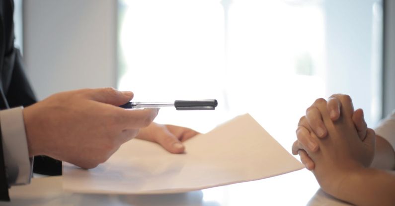 Inclusive Policy - Crop businessman giving contract to woman to sign