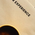 Customer Experience - A Top Shot of a Cup of Coffee on Brown Envelopes