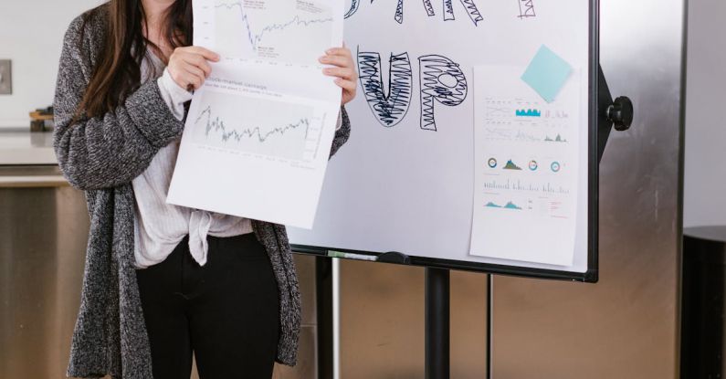 Financial Goals - Woman in Gray Coat Holding White Printer Paper