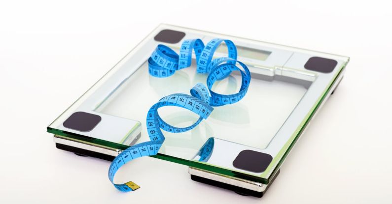 Scale - Blue Tape Measuring on Clear Glass Square Weighing Scale