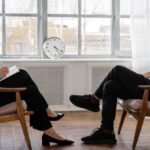 Psychology - Person in Black Pants and Black Shoes Sitting on Brown Wooden Chair